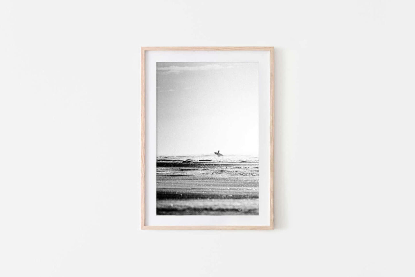 Framed Lone surfer walking toward surf on Central American coast, black and white surf photography print