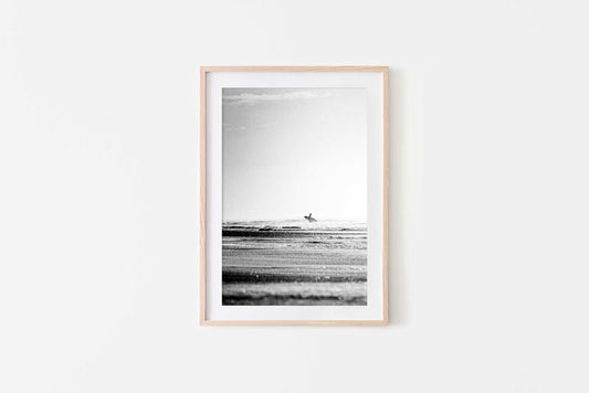 Framed Lone surfer walking toward surf on Central American coast, black and white surf photography print