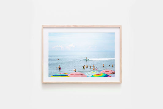 Colourful umbrellas on Sayulita beach, surf inspired ocean fine art photography print framed with natural timber and with a white matte board.