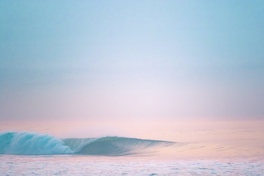 pastel sunrise over the ocean with barrelling wave in Guatemala
