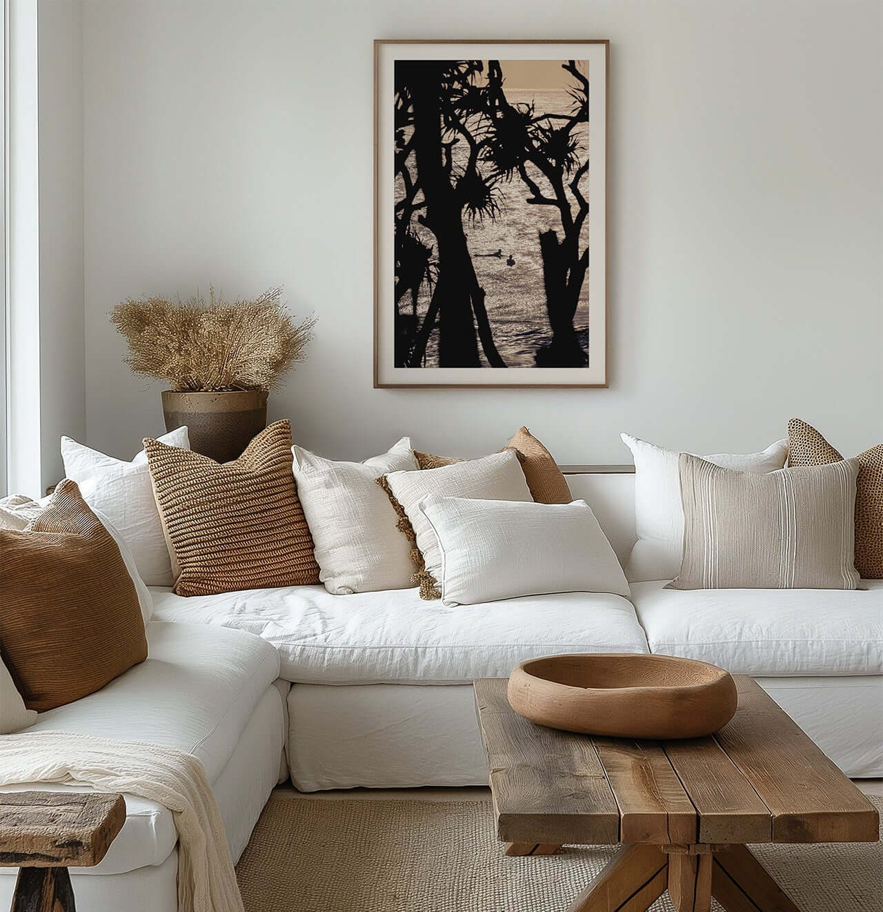 Cozy living room with a white sofa, wooden coffee table, and decorative pillows.