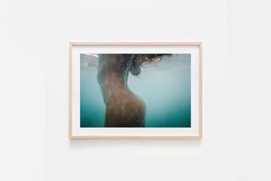 Framed artwork of female nude underwater with water textures