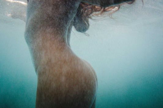 close up form of a underwater nude with bluewater textures