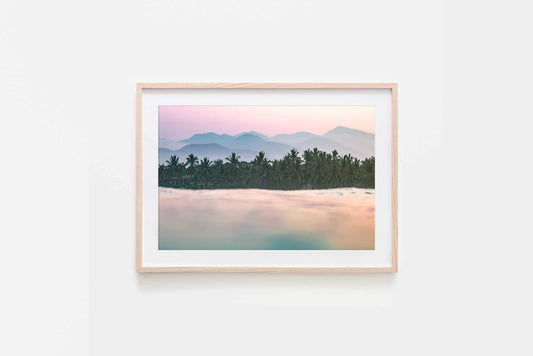 La Saladita sunrise art print featuring a tropical landscape with palm trees and mountains at dawn.
