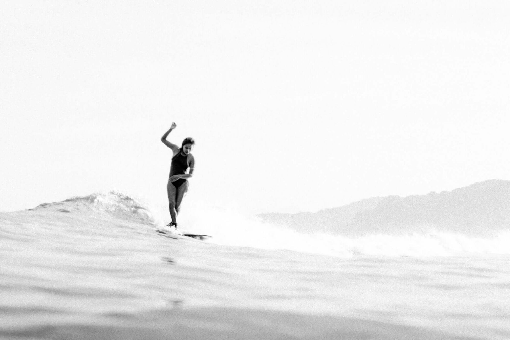 Minimalist black and white surf print with soft haze, surfer silhouette, and subtle ocean textures