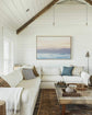 image of a soft pastel sunrise over the mountains and the ocean framed in a beautiful country style lounge room