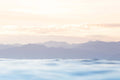 image of a soft pastel sunrise over the mountains and the ocean