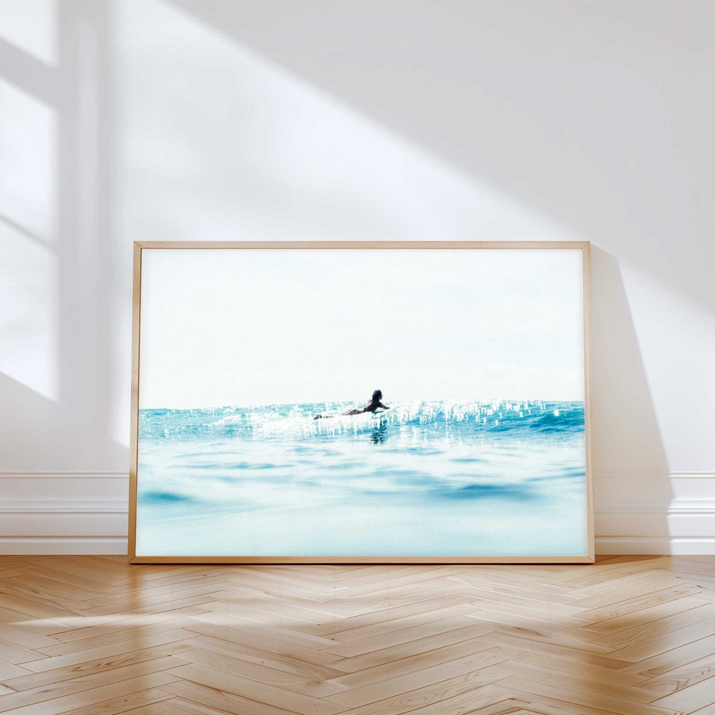 Dreamy ocean photography print — soft blue seas and morning light captured a surfer in Drift, a coastal fine art print.