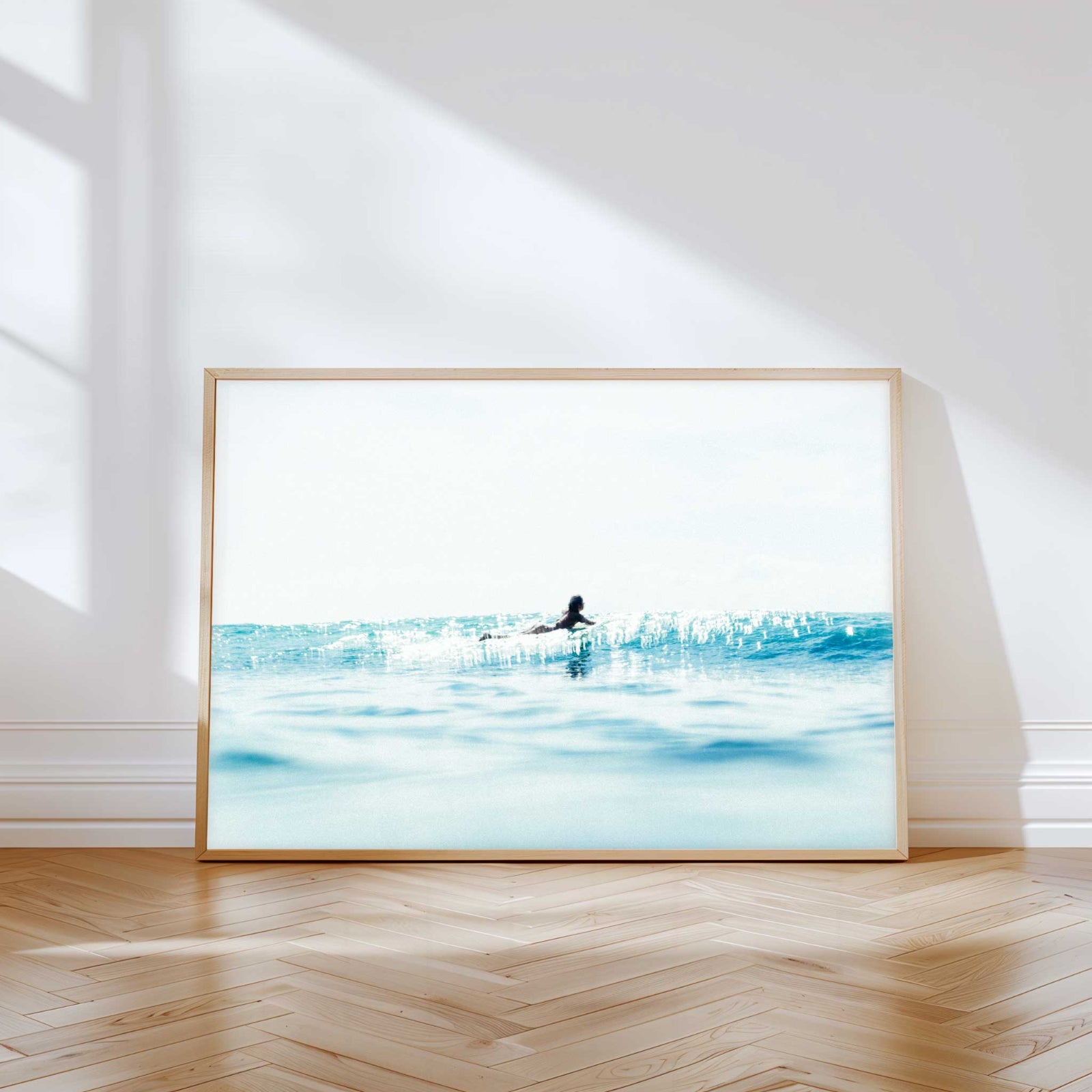 Dreamy ocean photography print — soft blue seas and morning light captured a surfer in Drift, a coastal fine art print.